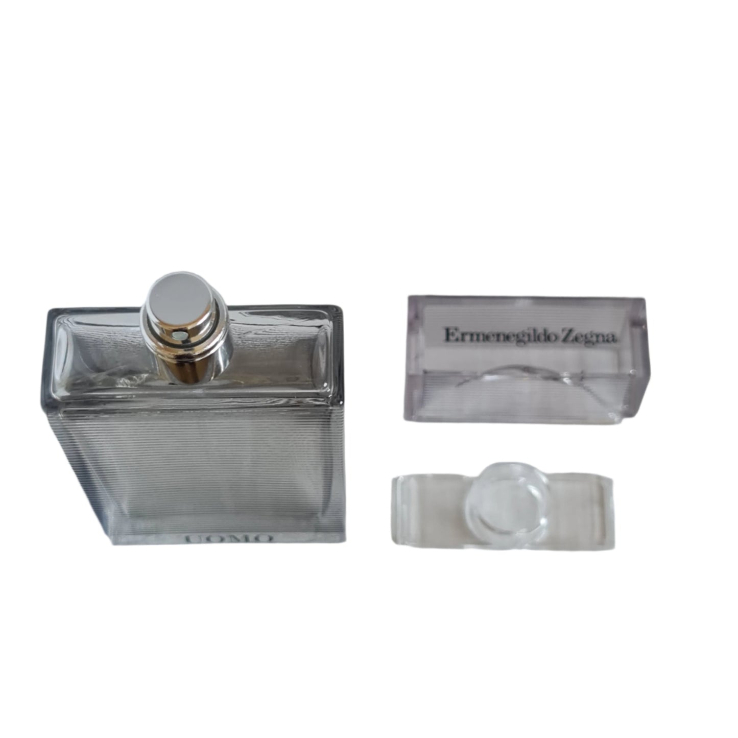Photo of fragrance bottle and cap.