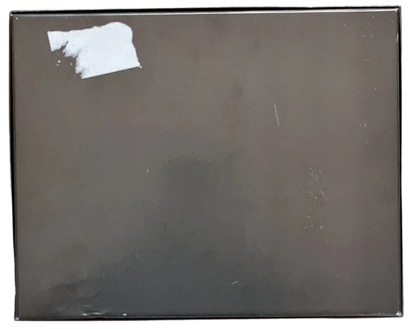 Rear photo of perfume box showing marks and sticker.
