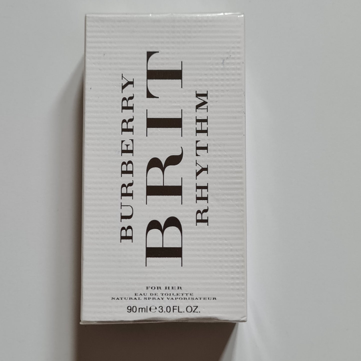 Burberry Brit Rhythm For Her Eau De Toilette 90ml.  Front bird's eye veiw photo of perfume and fragrance box.