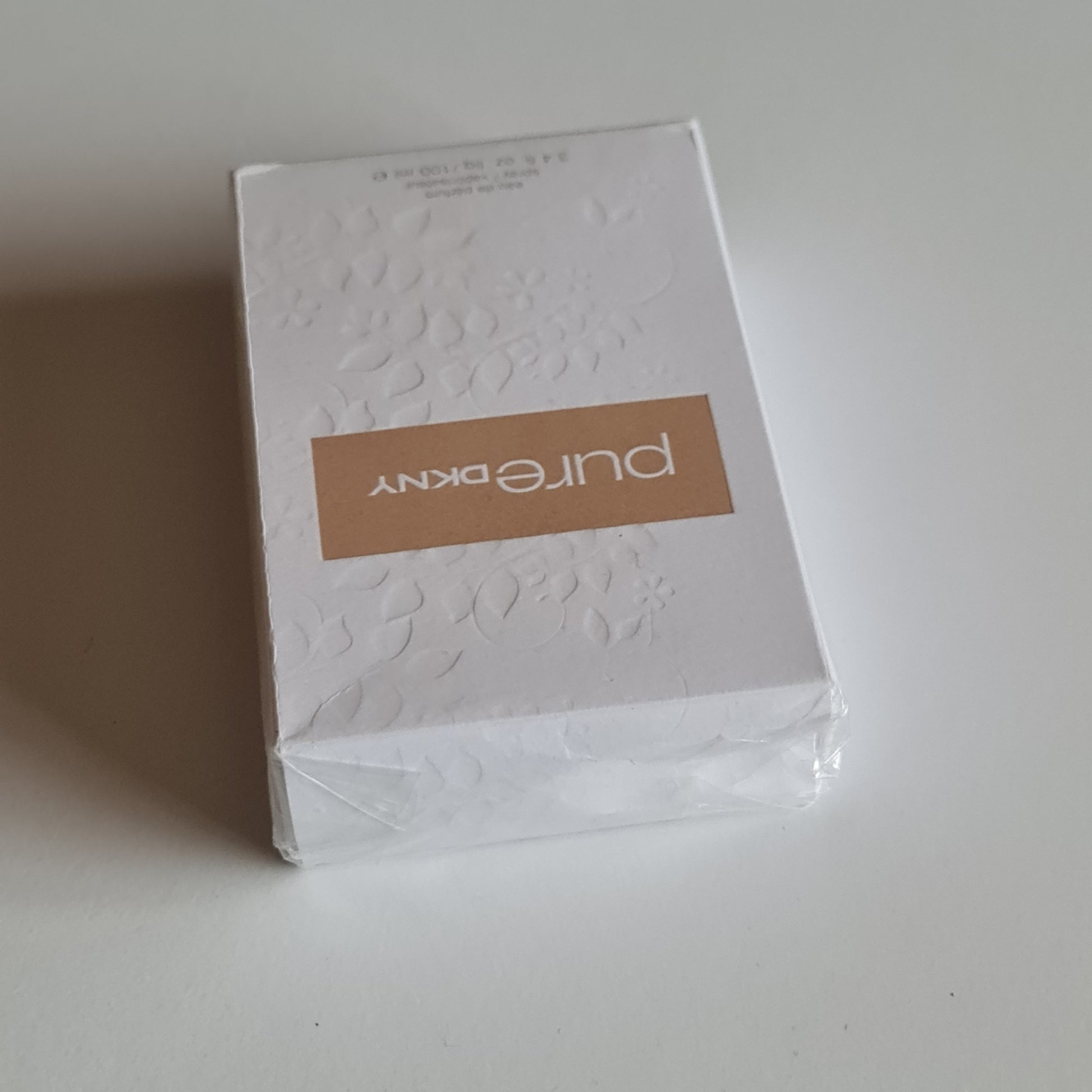 Cologne box lying flat showing top.
