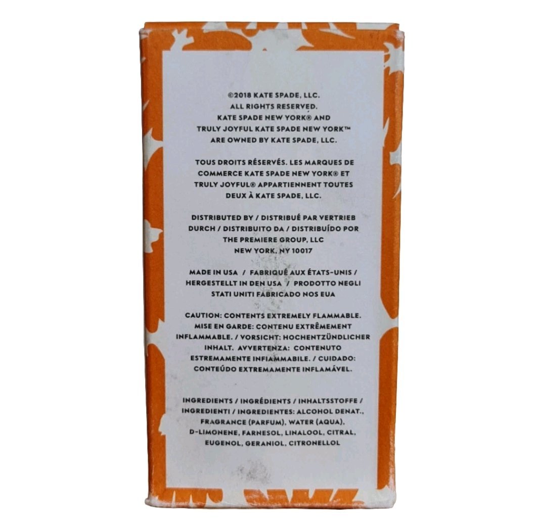 Kate Spade Truly Joyful Eau de Toilette 75ml Kate Spade Truly Joyful Eau de Toilette 75ml. Back of the orange perfume box showing the description.